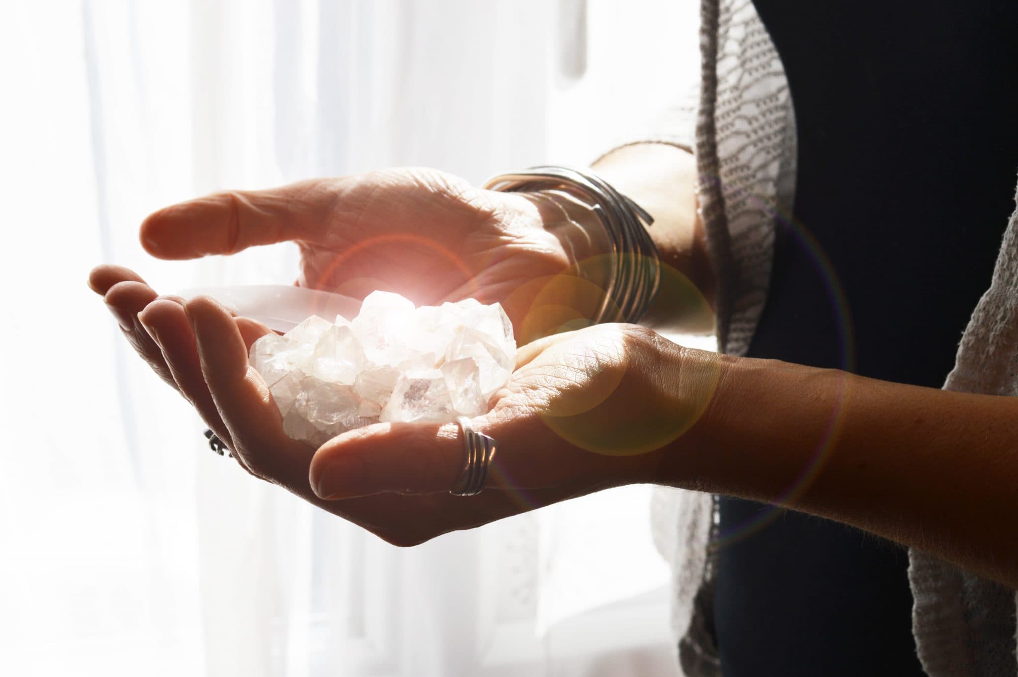 A crystal held to the light in cupped hands